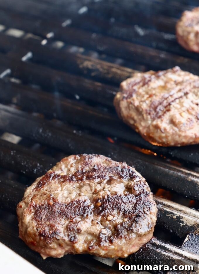 Smoky BBQ Bacon Burger Recipe 5 Burger patties cooking on a grill