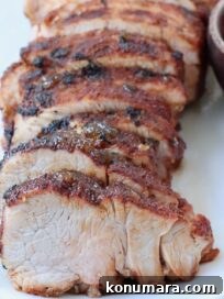 Grilled Pork Tenderloin Recipe with Garlic-Herb Rub 16 grilled pork tenderloin sliced on plate