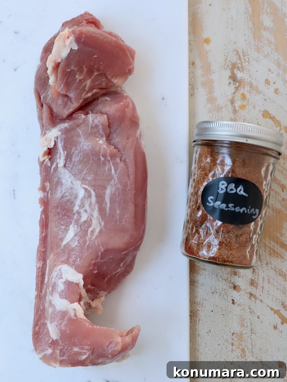 Grilled Pork Tenderloin Recipe with Garlic-Herb Rub 3 raw pork tenderloin and bbq seasoning on white wood board