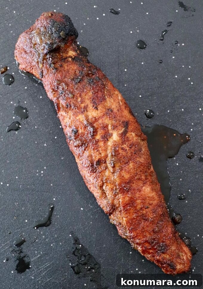 Grilled Pork Tenderloin Recipe with Garlic-Herb Rub 7 grilled pork tenderloin on cutting board