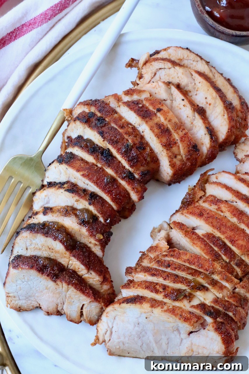 Grilled Pork Tenderloin Recipe with Garlic-Herb Rub 8 sliced grilled bbq pork tenderloin on plate