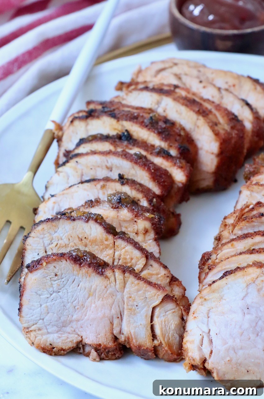 Grilled Pork Tenderloin Recipe with Garlic-Herb Rub 9 sliced grilled pork tenderloin on plate