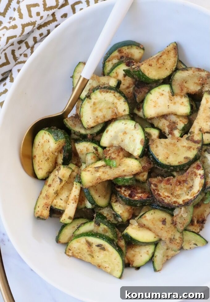 How to Cook Zucchini: Roast, Saute, Grill, Stir-Fry 11 cooked sliced zucchini in bowl with serving spoon