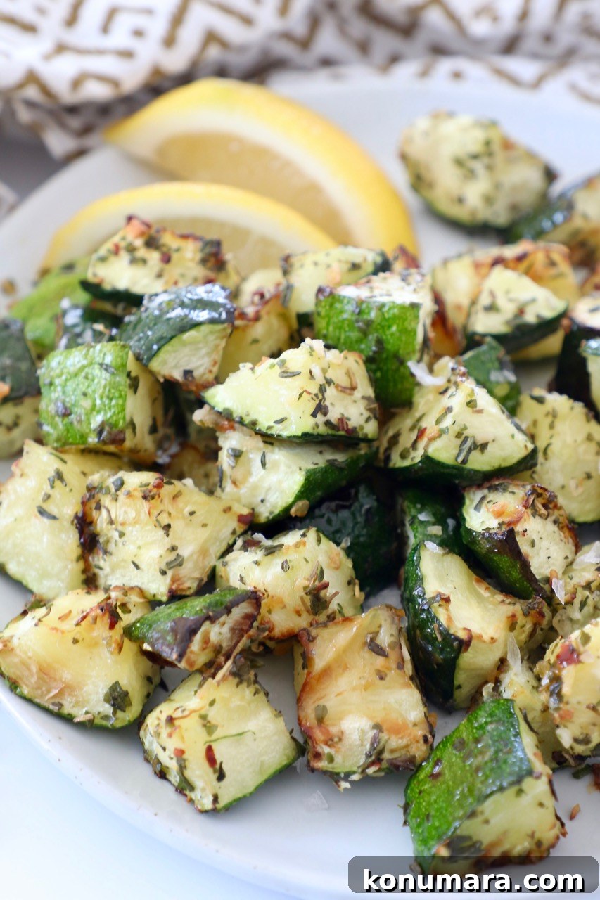 How to Cook Zucchini: Roast, Saute, Grill, Stir-Fry 17 diced cooked zucchini on plate with lemon wedges