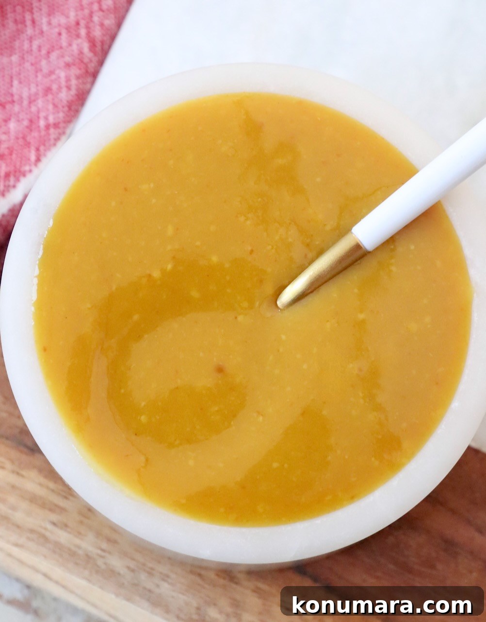 mustard bbq sauce in bowl with spoon