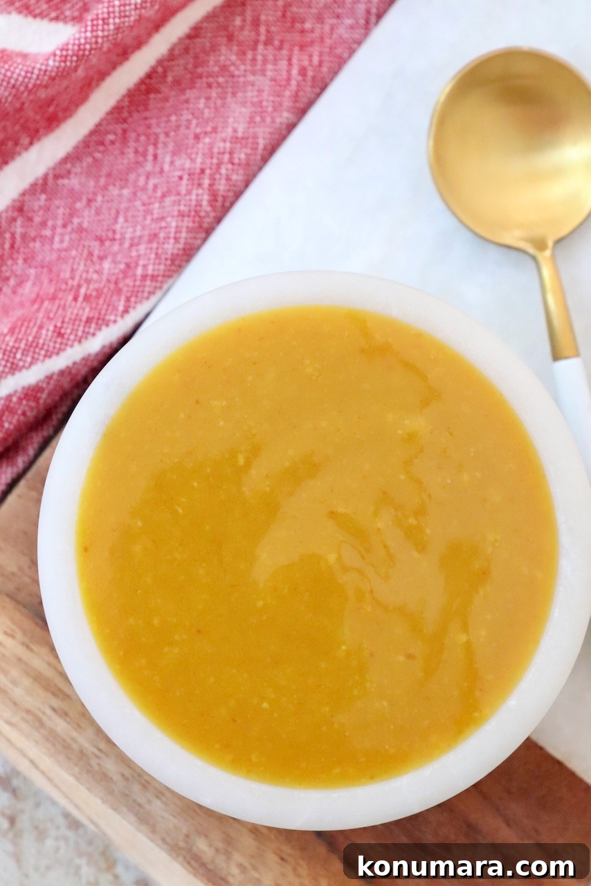 mustard bbq sauce in small bowl with spoon