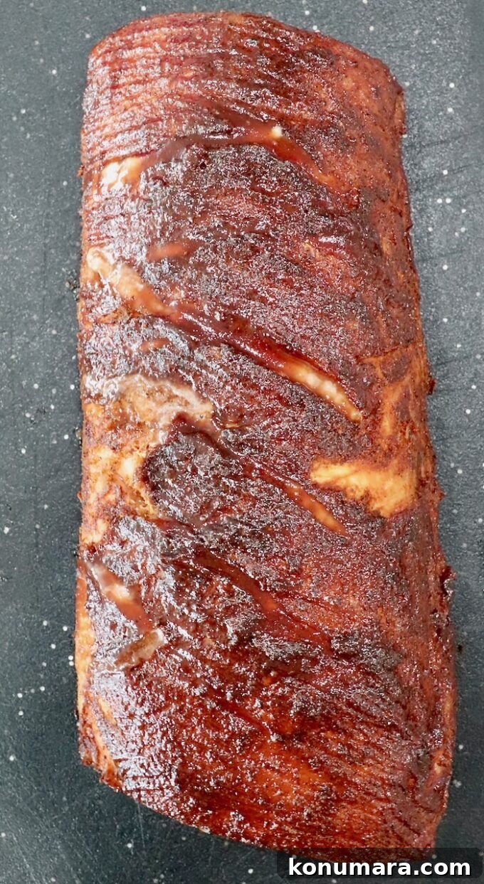 How to Smoke Pork Loin for Tender, Juicy Results 9 glazed smoked pork loin on cutting board