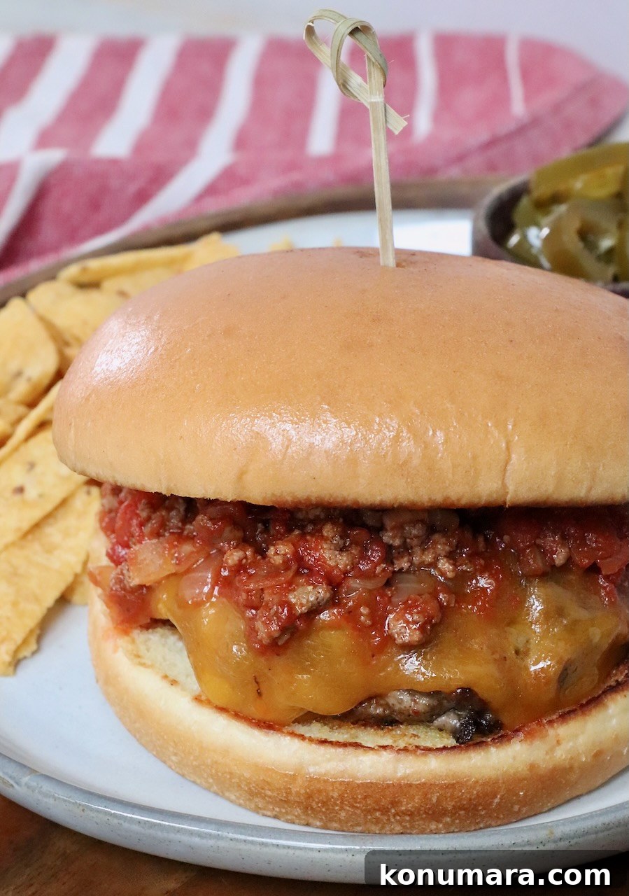 chili cheeseburger on plate with chips