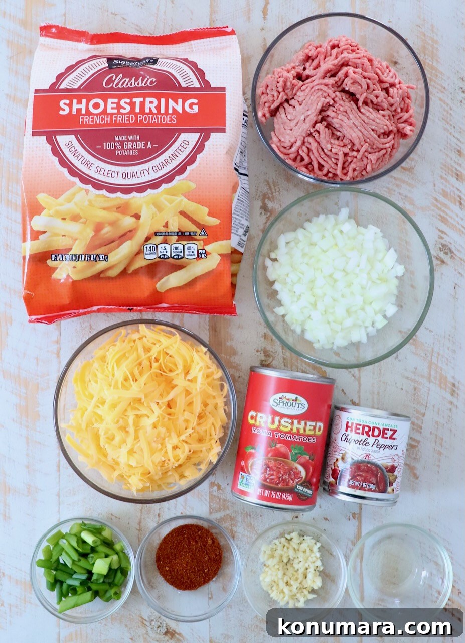 ingredients for chili cheese fries on white wood board