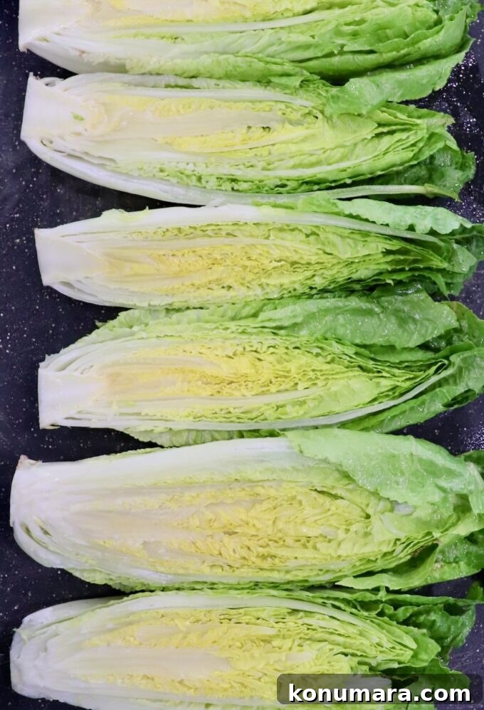 Grilled Caesar Salad with Charred Romaine and Garlic Croutons 11 romaine lettuce hearts cut in half on cutting board
