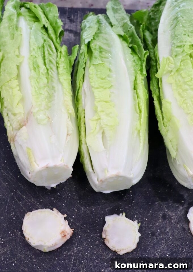 Grilled Caesar Salad with Charred Romaine and Garlic Croutons 10 romaine lettuce on cutting boards with the stems cut off
