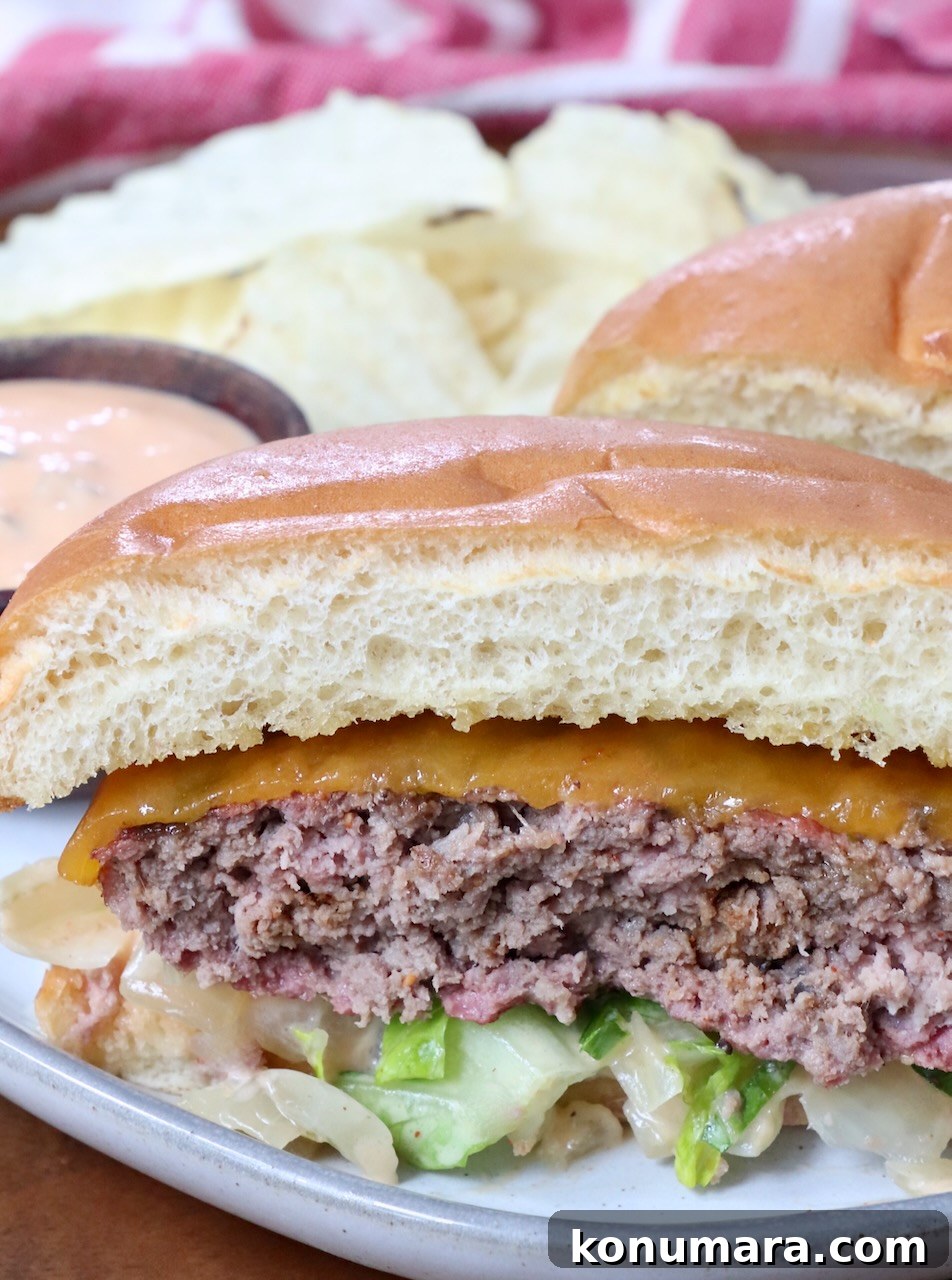 smoked burger cut in half on plate