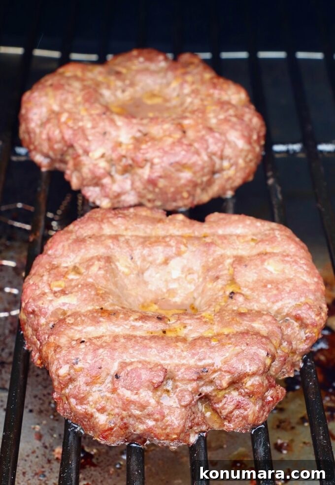 smoked burger patties on a smoker