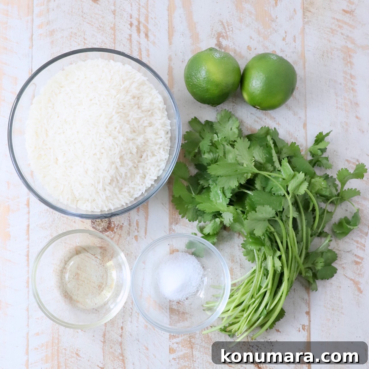 ingredients for cilantro lime rice on white wood board