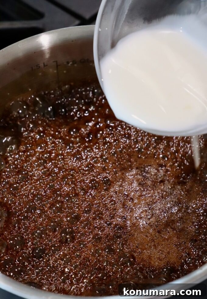 cornstarch slurry poured into a pot of teriyaki sauce on the stove