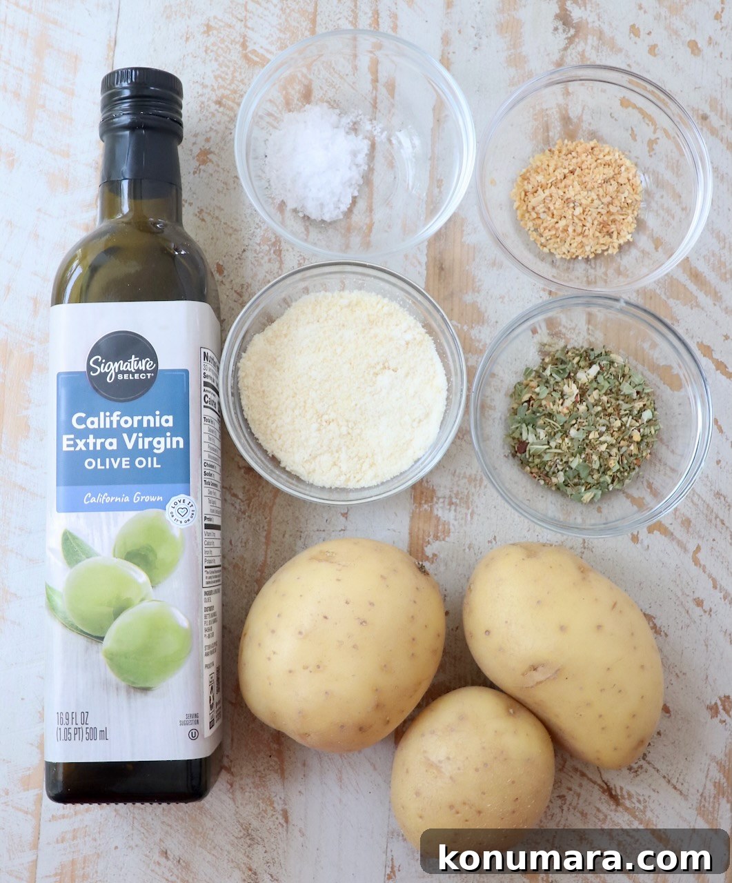 ingredients for air fryer roasted potatoes on white wood board