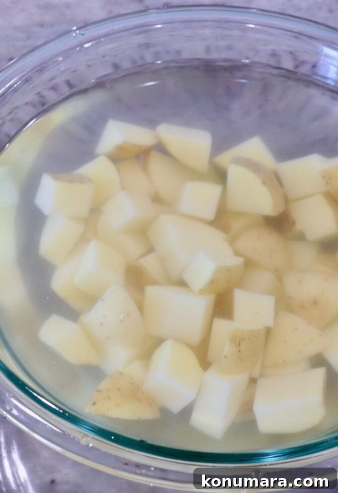 cubed potatoes in a bowl of water