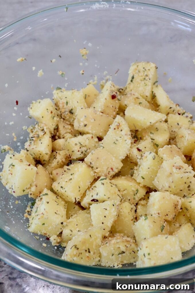 seasoned cubes of potatoes in a glass bowl