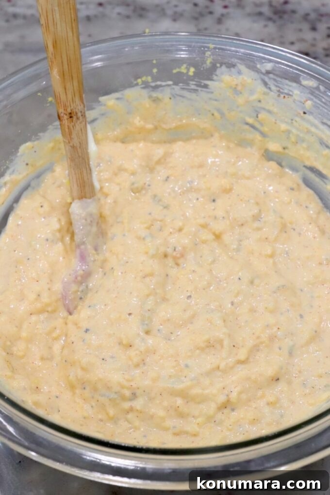deviled egg pasta salad dressing in glass bowl with a spatula