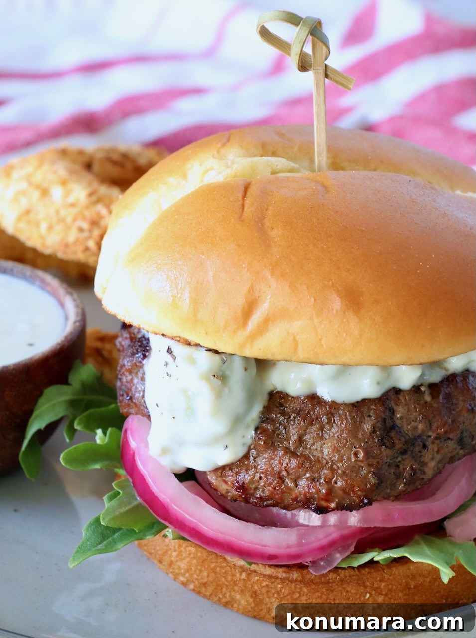 Classic Blue Cheese Burger Recipe 2 grilled burger on plate topped with blue cheese sauce