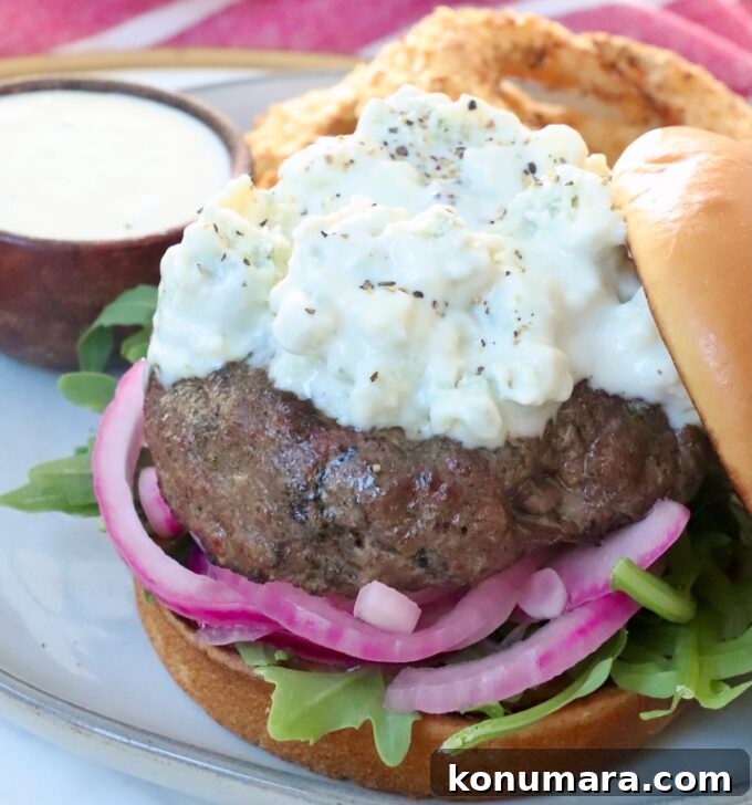 Classic Blue Cheese Burger Recipe 9 grilled burger patty topped with blue cheese sauce on plate