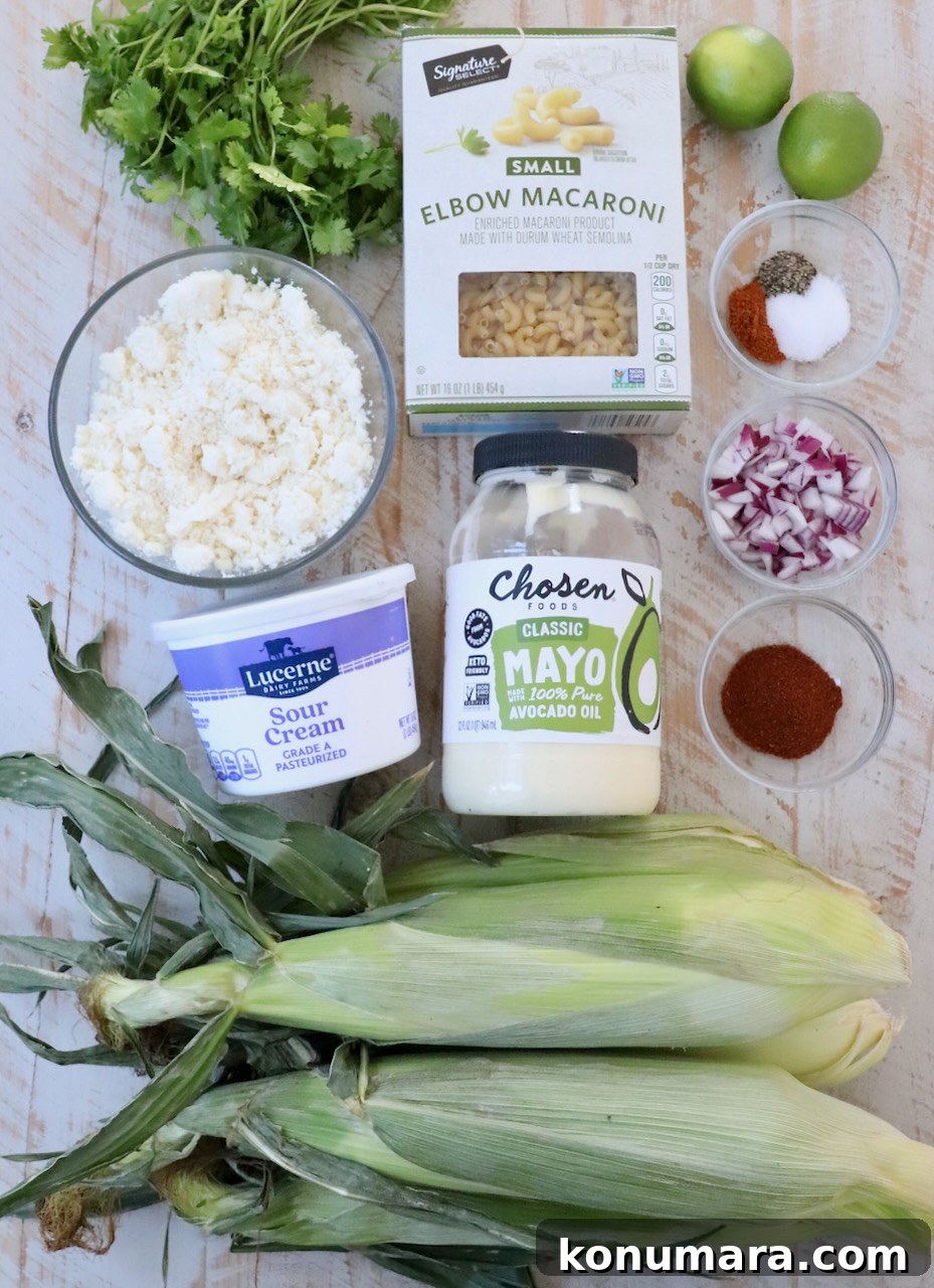 Elote Pasta Salad with Roasted Corn and Cotija 3 ingredients for Mexican street corn pasta salad on white wood board