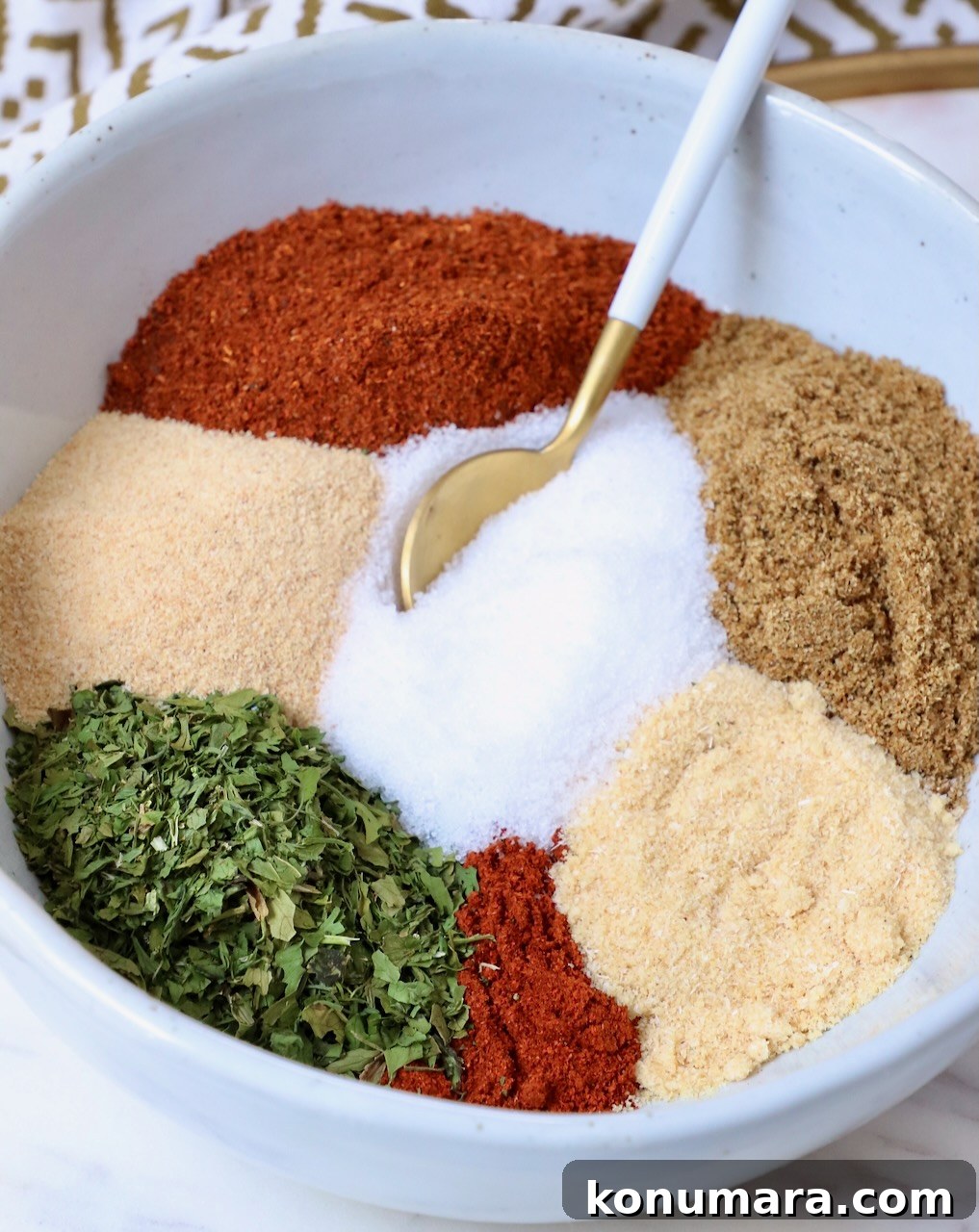 Authentic Carne Asada Seasoning for Tacos and Grilling 6 herbs and spices separated in bowl with spoon