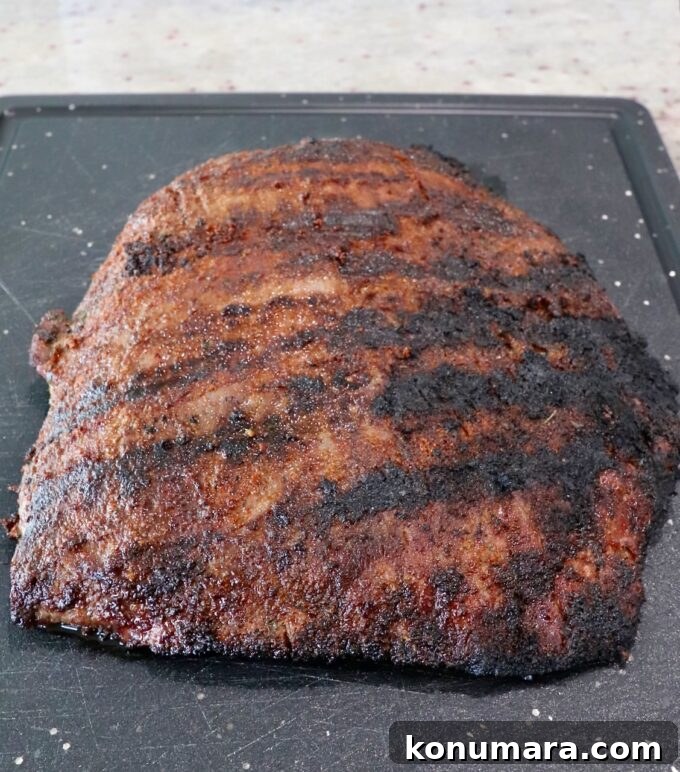 Authentic Carne Asada Seasoning for Tacos and Grilling 10 grilled flank steak on cutting board