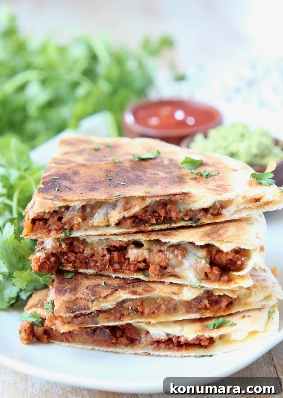 Soy Chorizo Quesadilla Recipe: Crispy Cheese Tortilla 2 Soy chorizo quesadilla slices stacked up on a plate with fresh cilantro