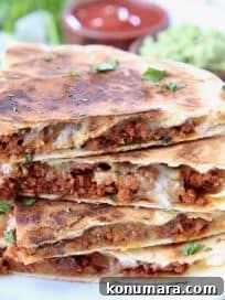Stacked up slices of soy chorizo quesadilla on plate