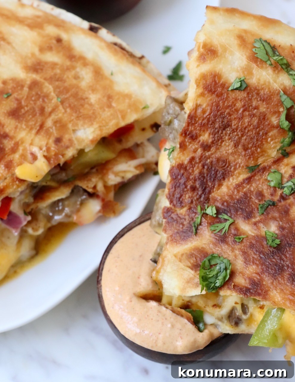 quesadilla dipped into a small bowl of creamy sauce