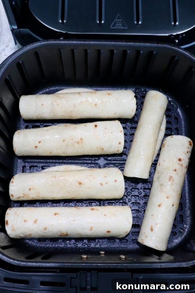 Homemade Crispy Beef Taquitos Recipe 8 uncooked taquitos in air fryer basket