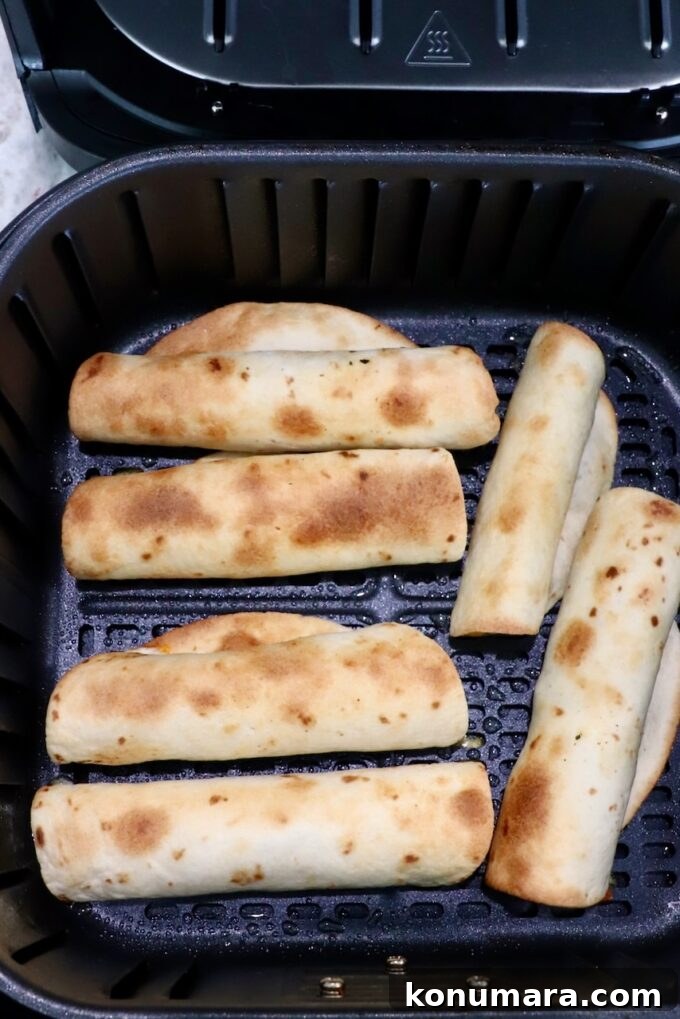 Homemade Crispy Beef Taquitos Recipe 9 cooked taquitos in air fryer basket