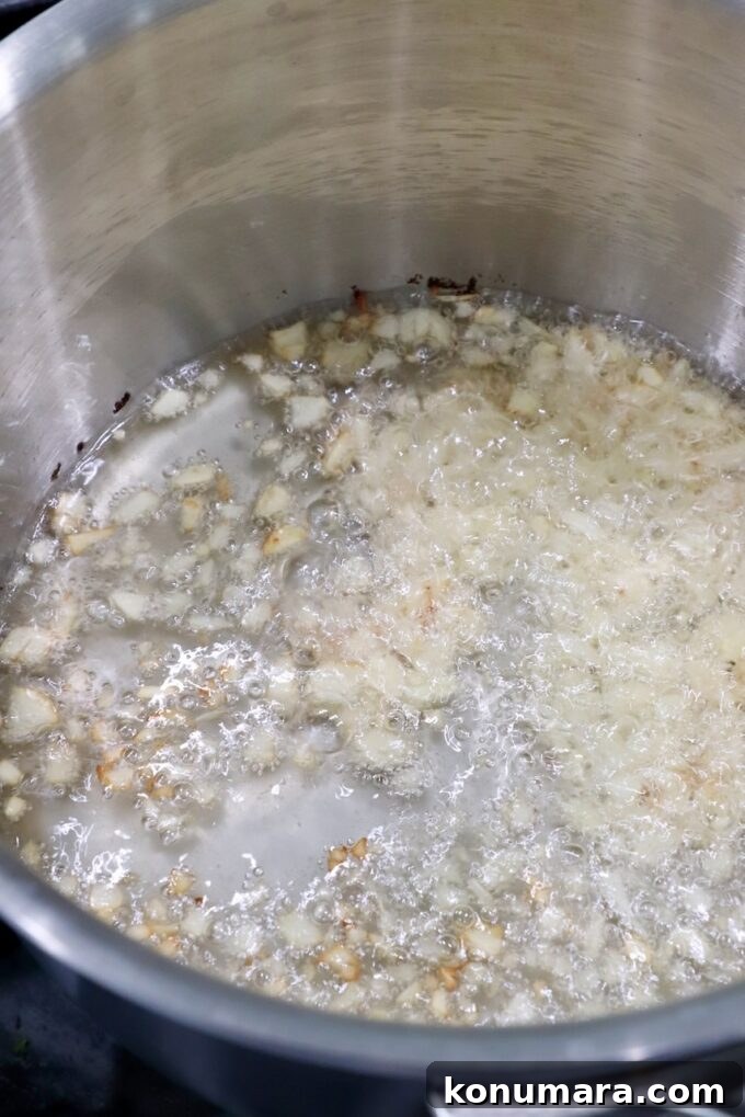 Salsa Macha: Mexican Chili Oil Recipe 6 garlic cooking in oil in a saucepan
