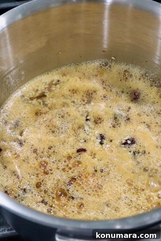 Salsa Macha: Mexican Chili Oil Recipe 7 dried chiles, peanuts and garlic in oil in saucepan on the stove