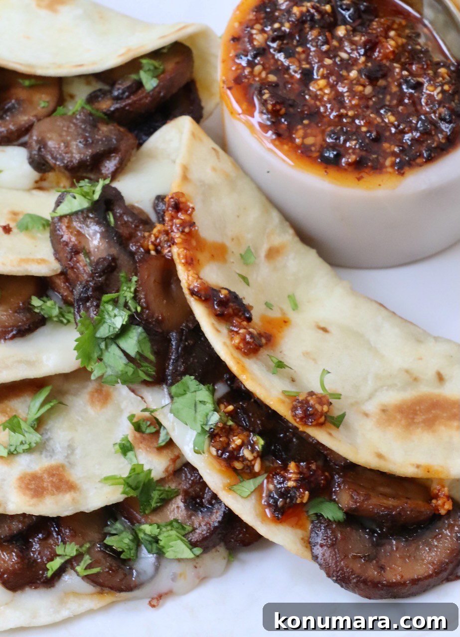 Salsa Macha: Mexican Chili Oil Recipe 8 mushroom tacos on a plate with salsa macha on the side