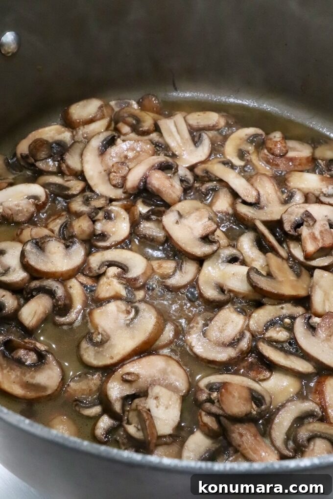 Flavorful Mushroom Tacos Recipe 5 Sliced mushrooms with broth in skillet