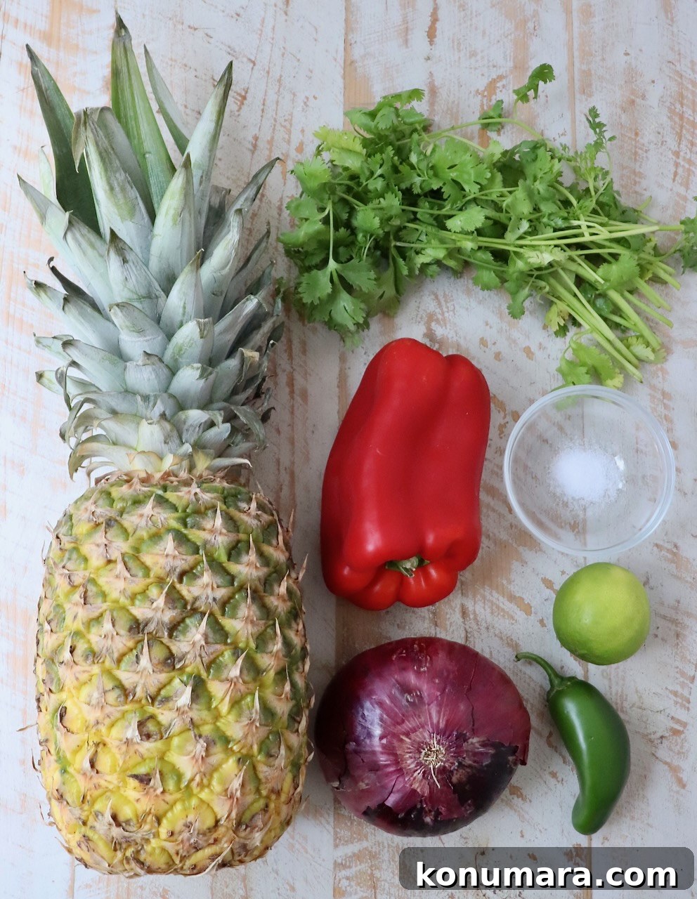 ingredients for pineapple salsa on white wood board