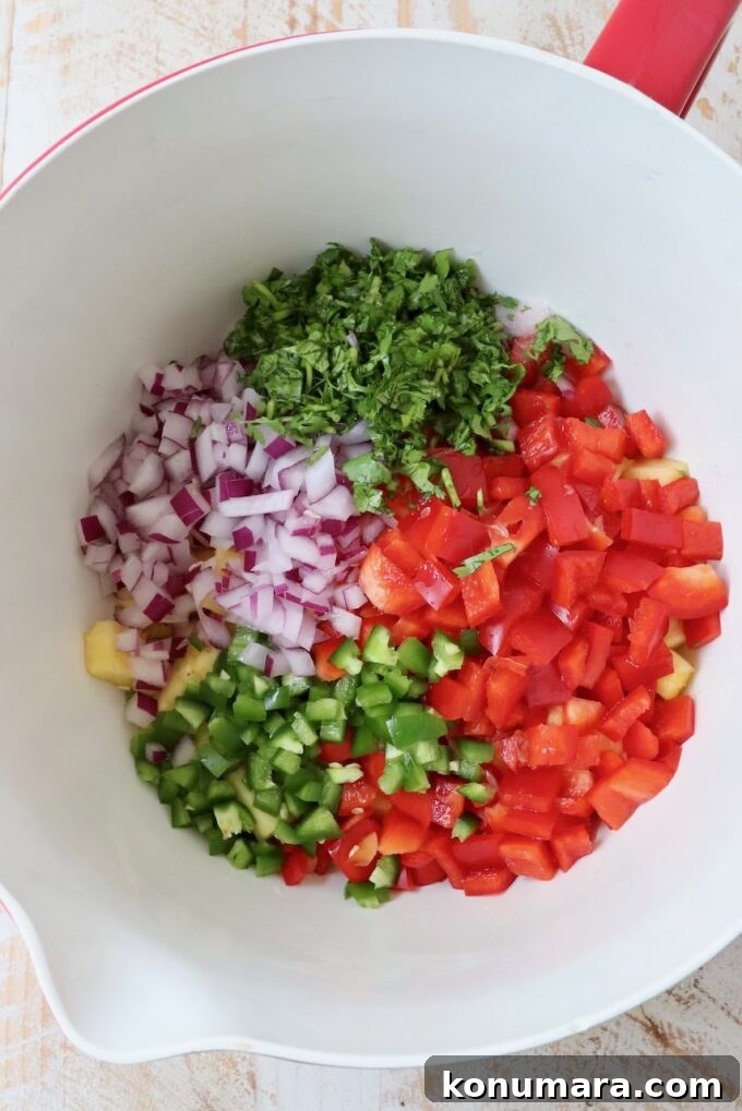 diced vegetables and pineapple in a large mixing bowl