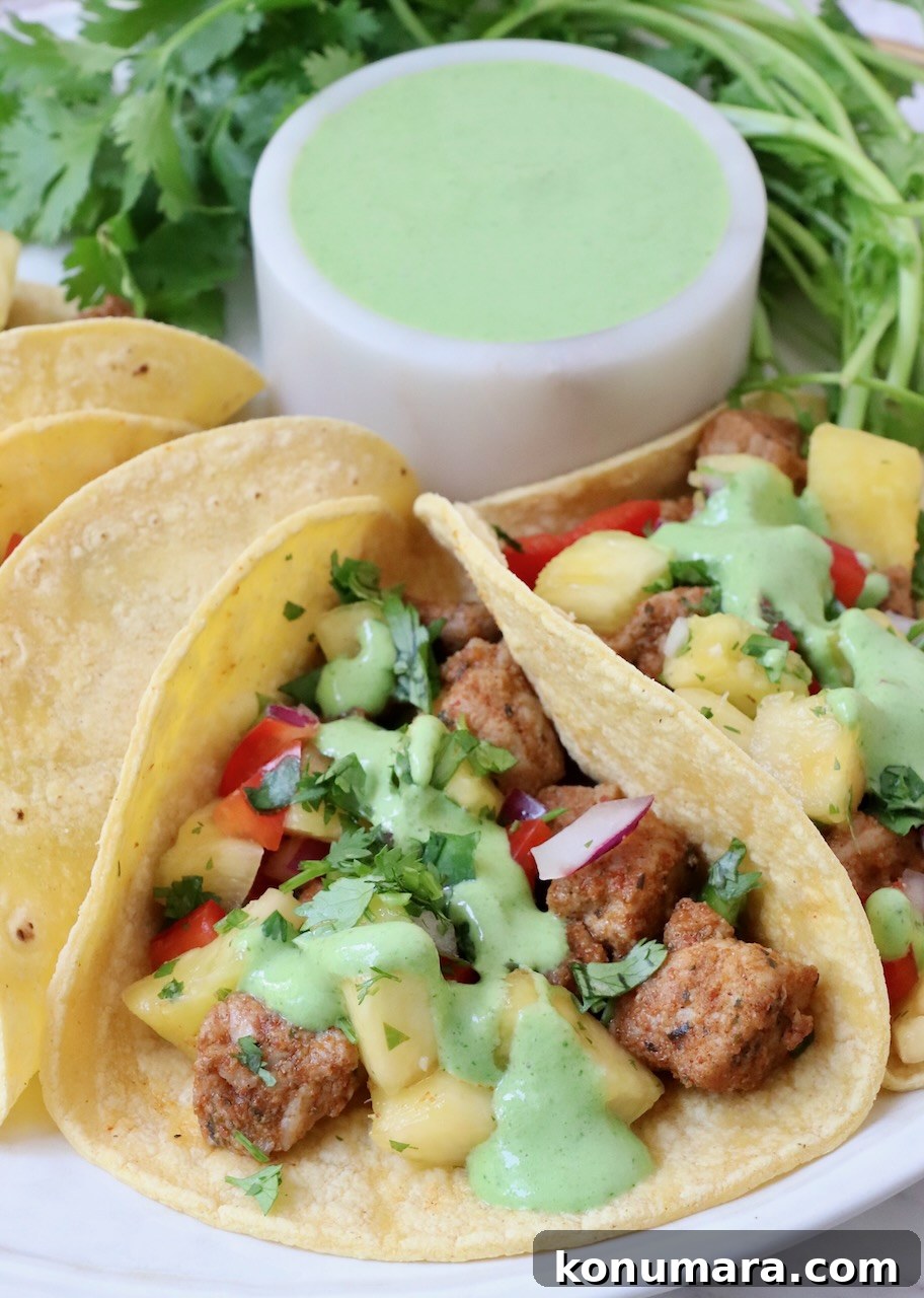 Homemade Carnitas Tacos Recipe with Salsa Verde 6 pork tacos topped with cilantro sauce on a plate