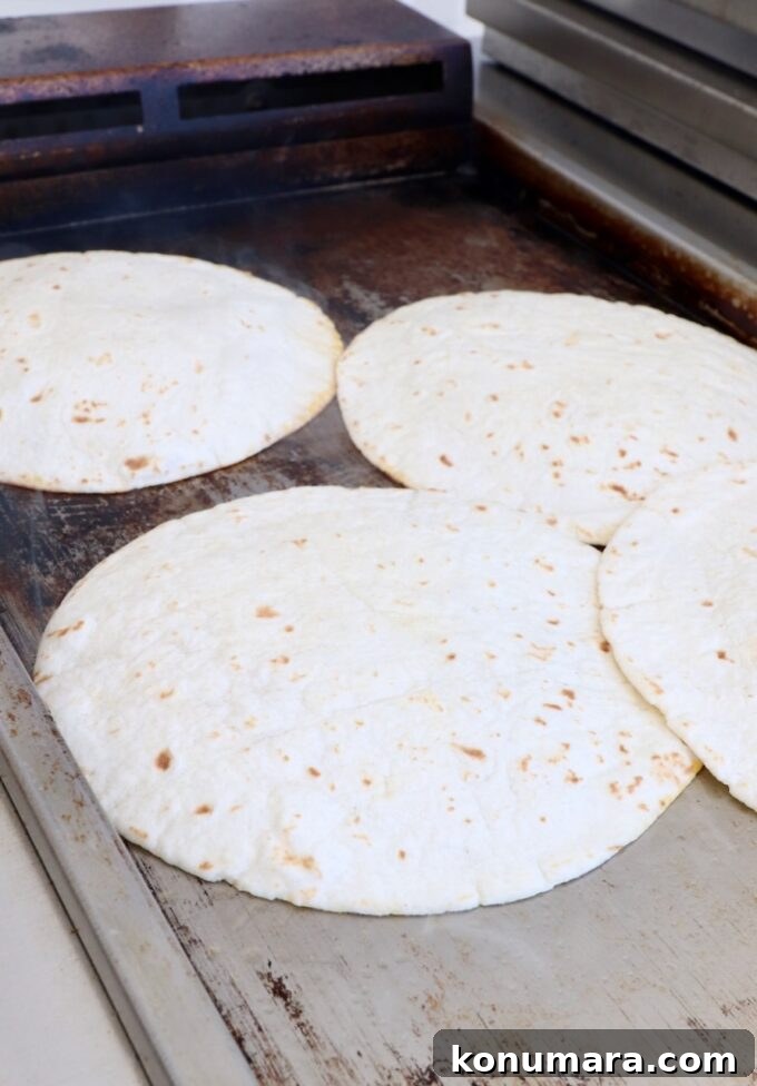 Smash Burger Taco Recipe: Crispy Smashed Patties 7 Tortillas on a griddle