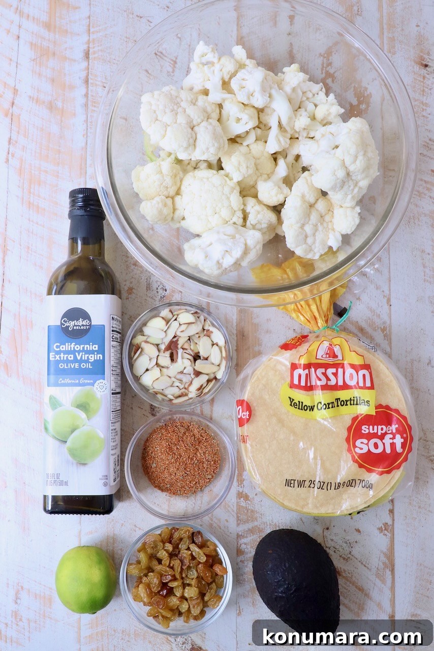 ingredients for cauliflower tacos on white wood board