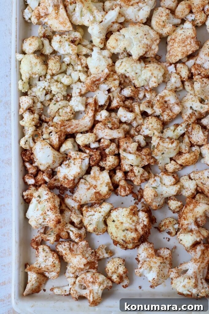 seasoned cauliflower florets on baking sheet