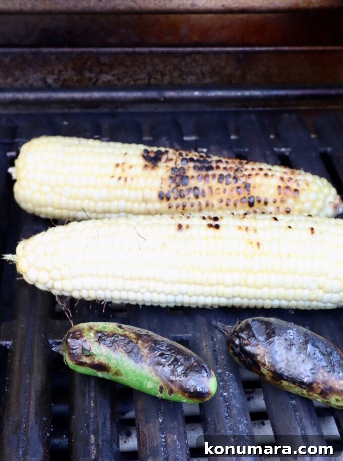 Elote Chicken Tacos with Mexican Street Corn 7 grilled corn on the cob and jalapenos on a grill