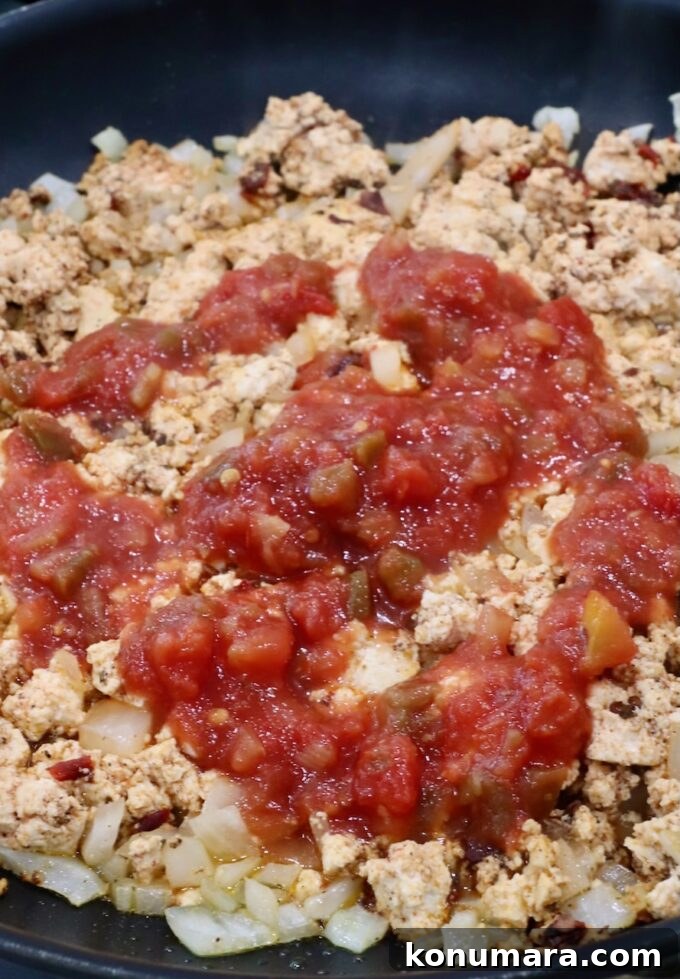 crumbled tofu topped with salsa in a skillet