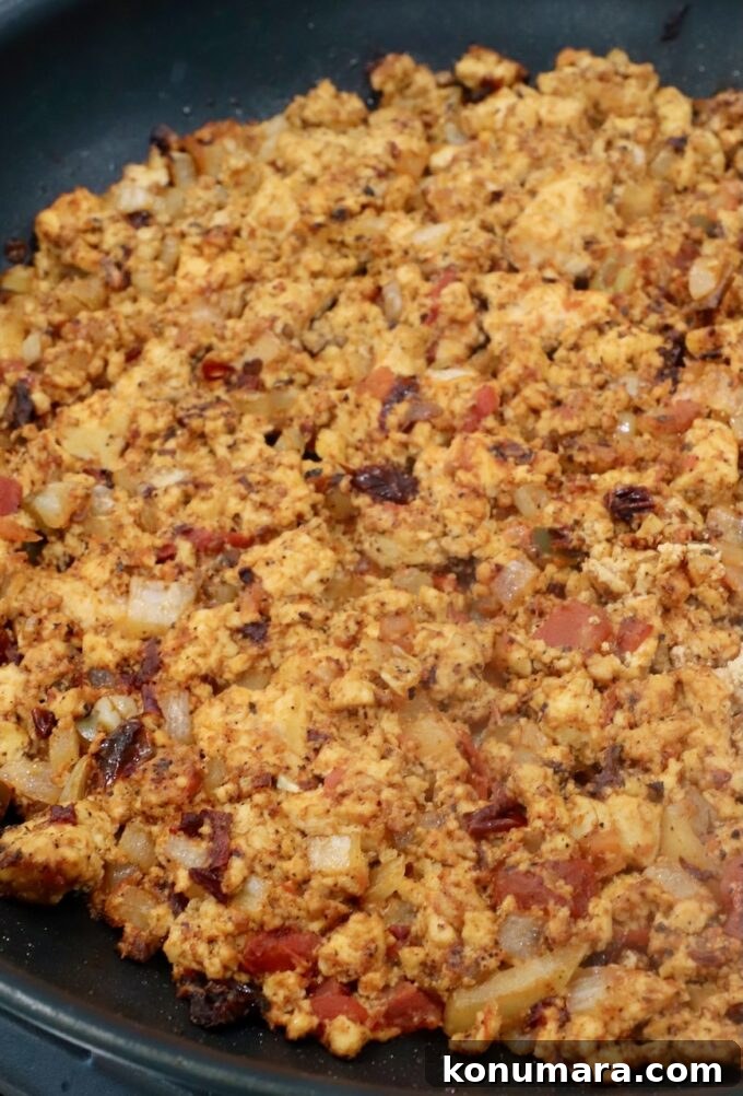 seasoned, cooked, crumbled tofu in a skillet