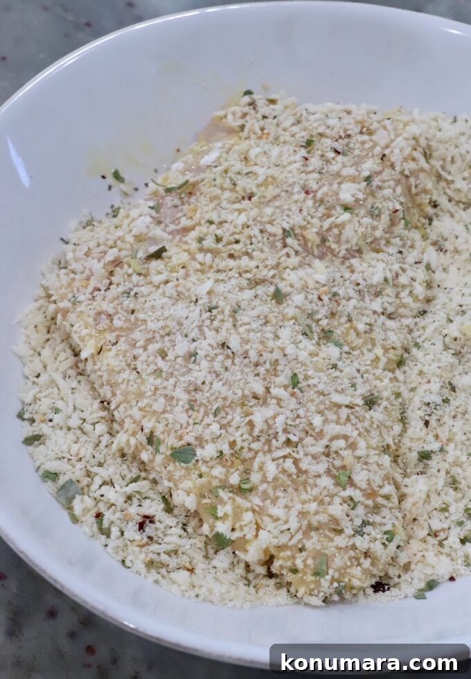 Crispy Parmesan-Crusted Chicken Recipe 9 chicken breast in a bowl of breadcrumbs