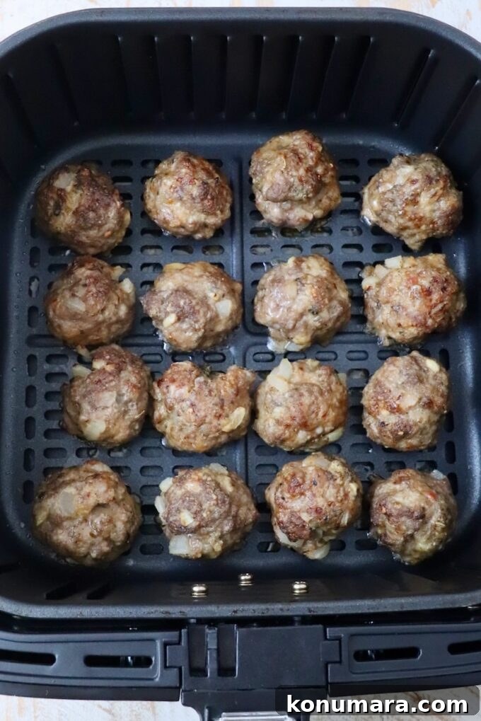 Crispy, Juicy Air Fryer Meatballs Recipe 7 cooked meatballs in air fryer basket