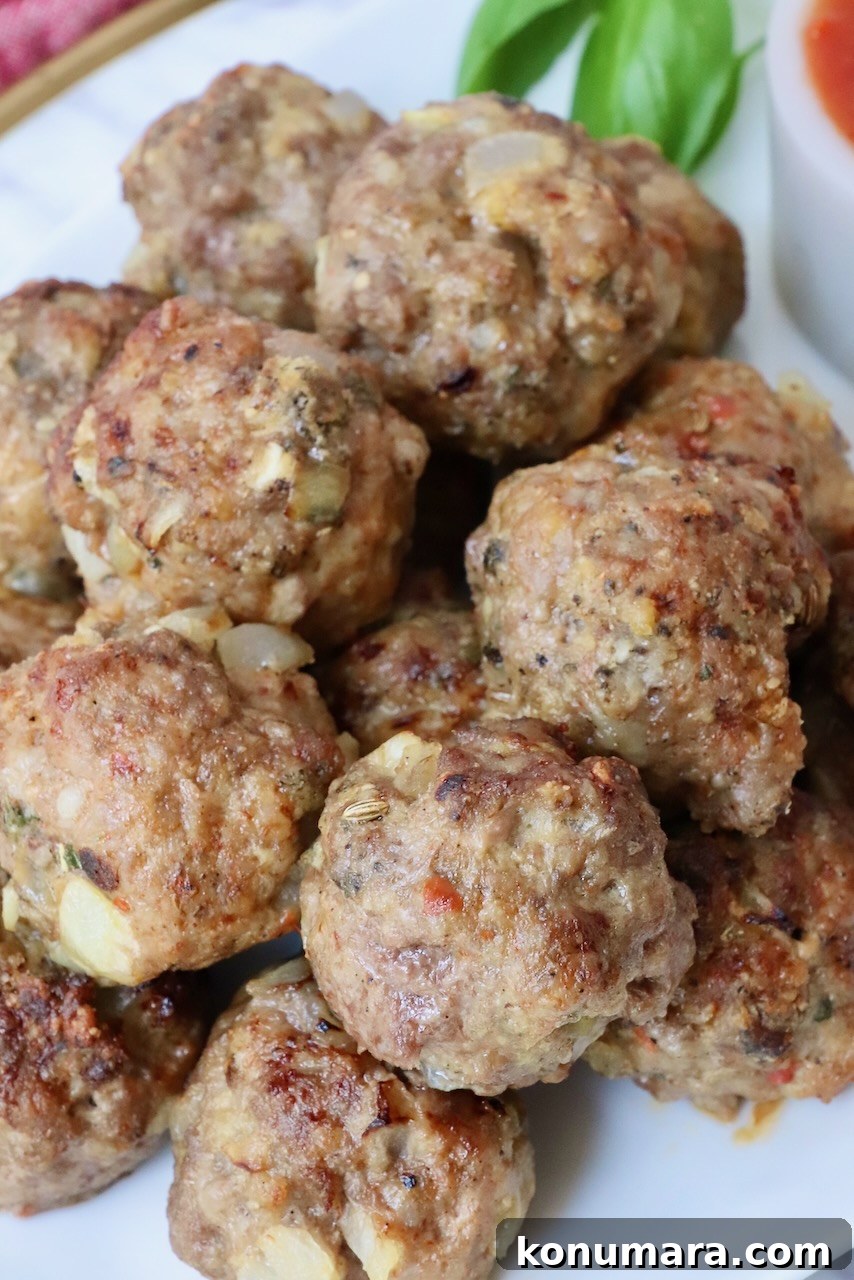 Crispy, Juicy Air Fryer Meatballs Recipe 9 cooked meatballs on a plate