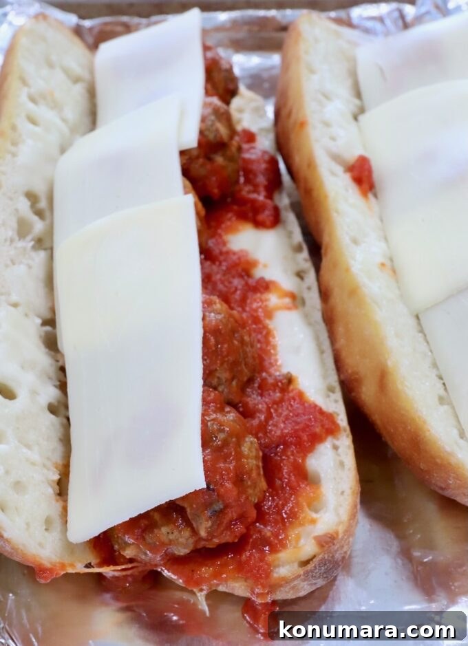 Classic Meatball Sub Recipe with Marinara and Mozzarella 9 meatballs tossed in marinara sauce in a baguette topped with slices of mozzarella cheese